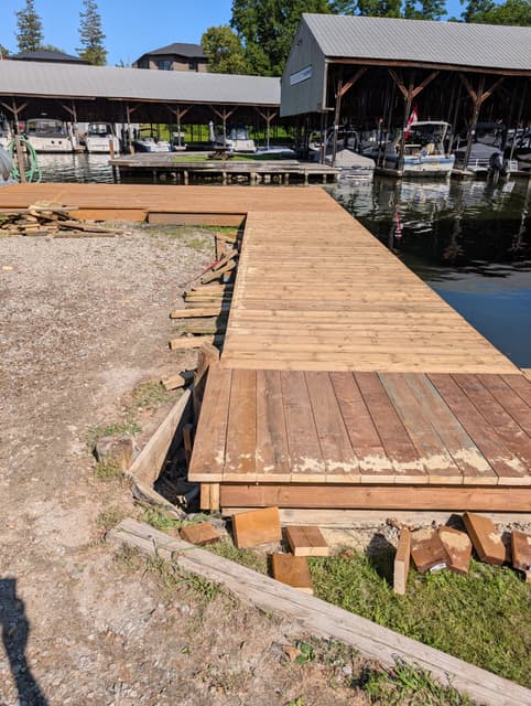 New decking runs the full length of the pier past the covered slips.