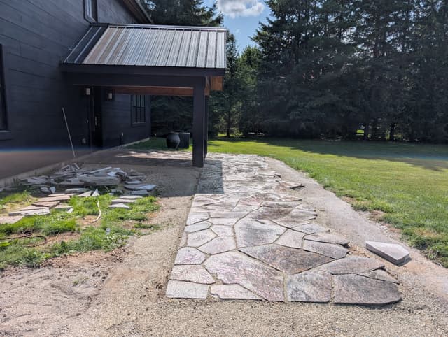 Granite flagstone walkway laid on compacted screenings, running out from the covered entry. — Collingwood, Ontario