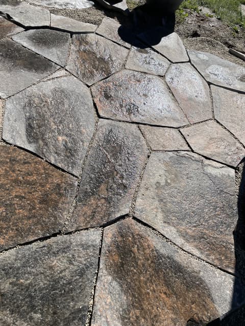 Close fit between granite flagstones, each edge chiselled to follow the stone beside it and the joints packed with fine gravel. — Collingwood, Ontario