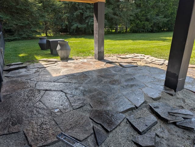 Stones set out on the bedding gravel and sorted for fit before being laid into the field. — Collingwood, Ontario