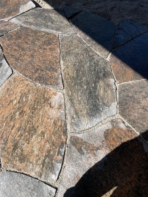 Granite faces and swept joints seen close up, the stone left with its natural cleft texture. — Collingwood, Ontario