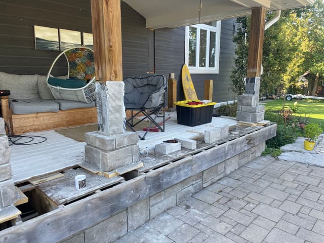 Stone veneer going up the porch skirt, with the first courses wrapping a column base. — Georgian Bay, Ontario